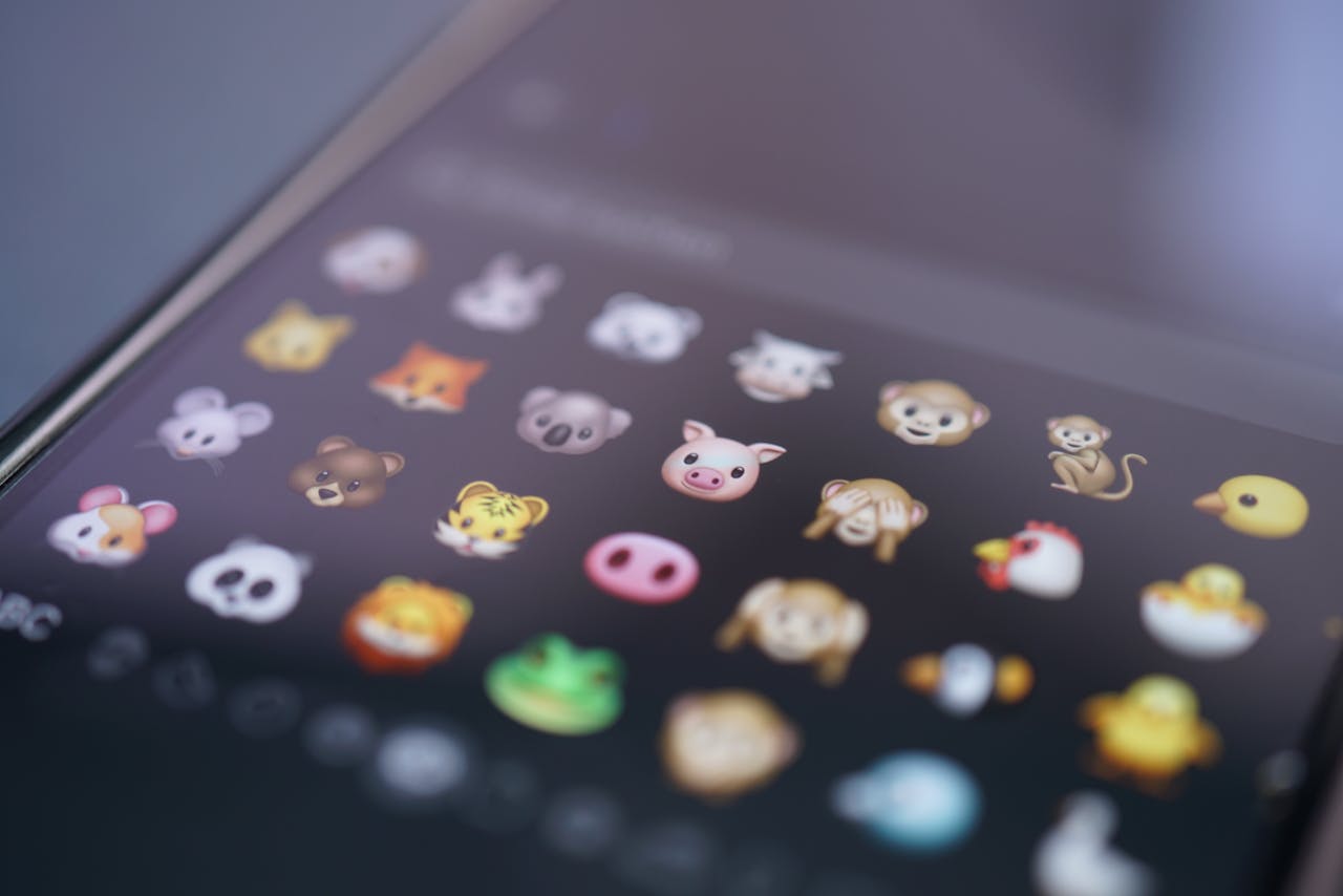 Close-up view of various animal emojis displayed on a smartphone screen, representing digital communication.