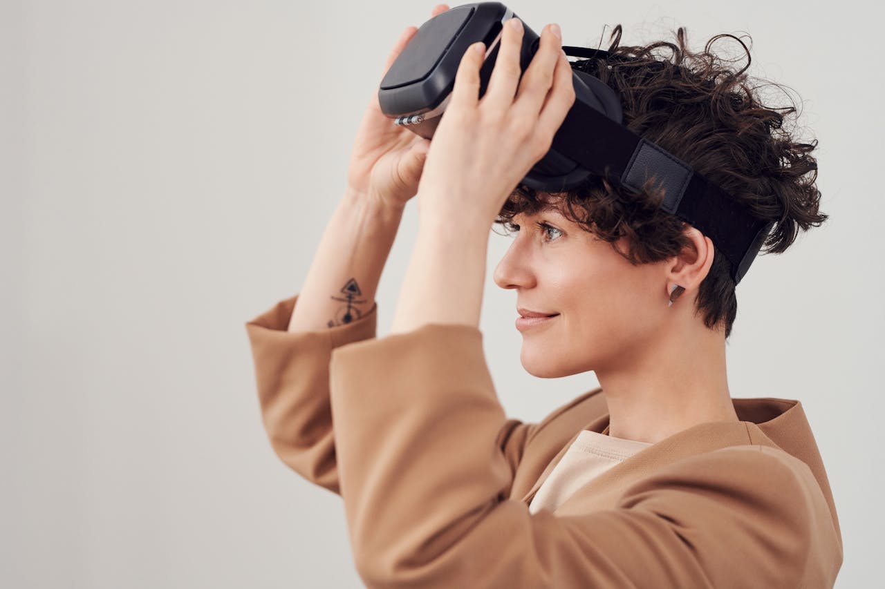 Side view of a woman enjoying virtual reality with a VR headset in a studio setting.