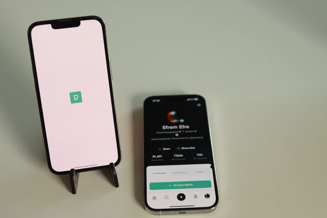 Close-up of two smartphones on a desk displaying a social media platform interface in Jönköping, Sweden.